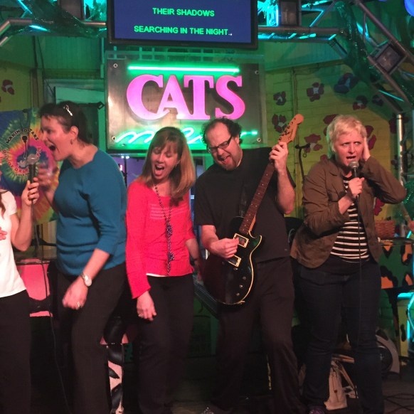 People on stage performing at a team meetup in New Orleans