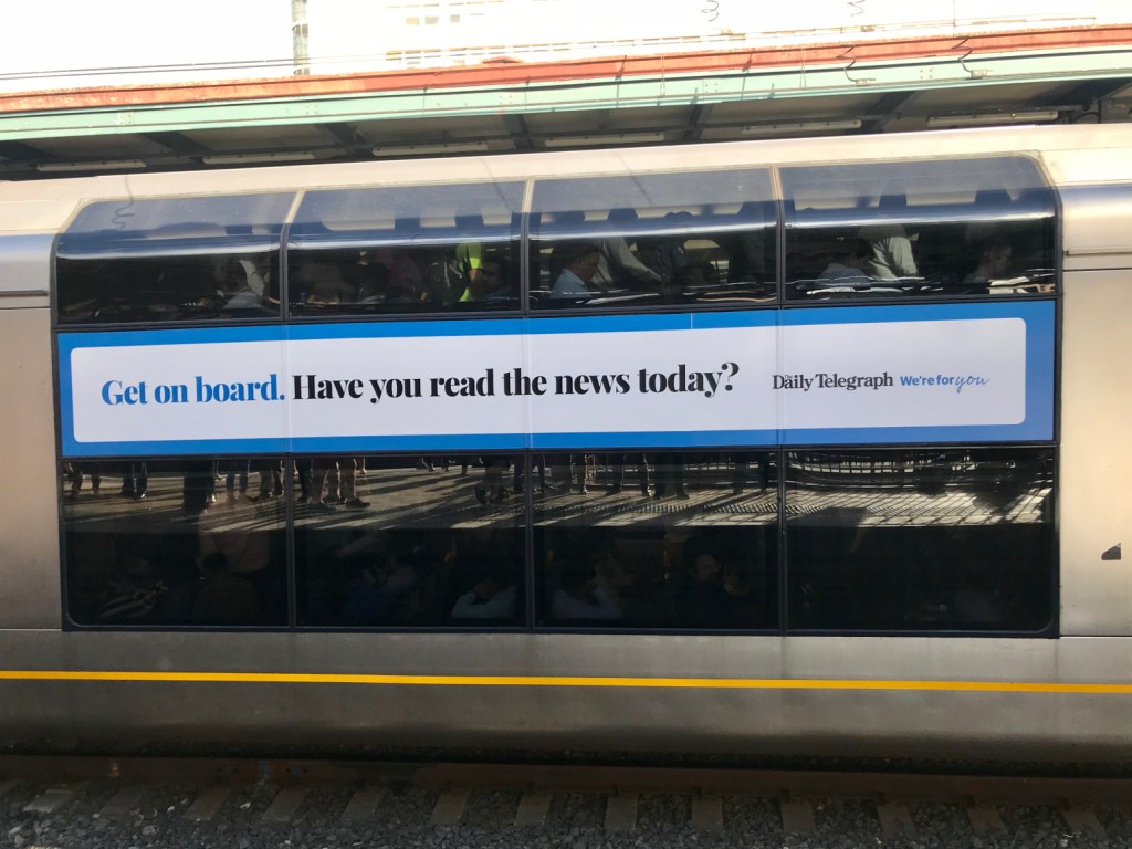 A transit ad from the Daily Telegraph which says 'Get on board. Have you read the news today'