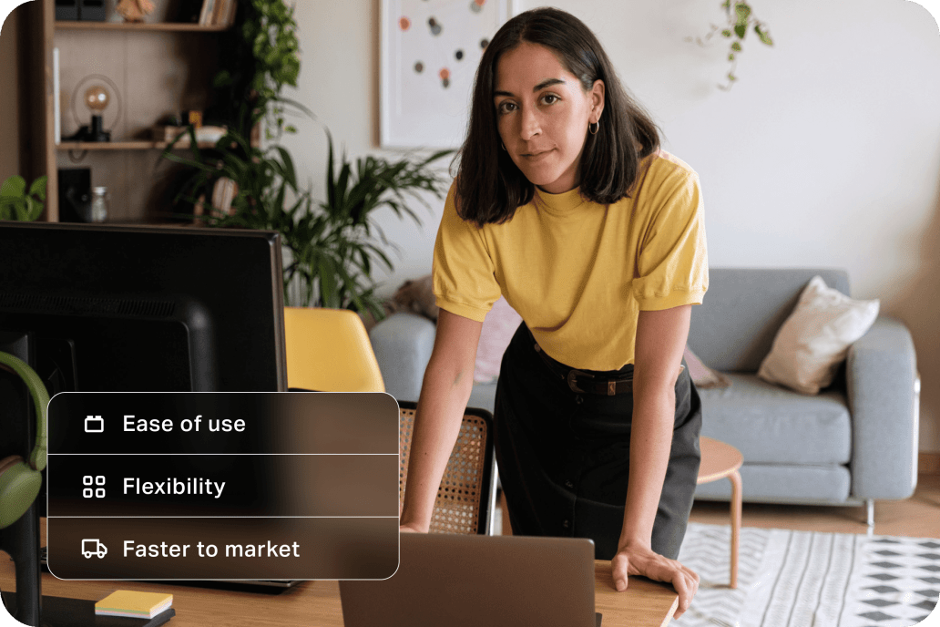 Young woman marketing professional leaning over desk looking confident