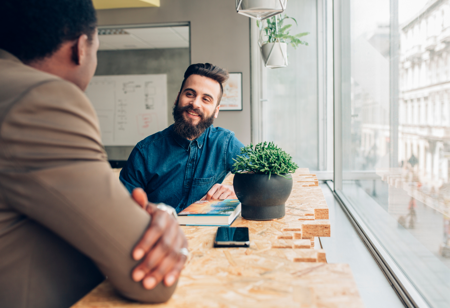 Two businessmen chatting at work.